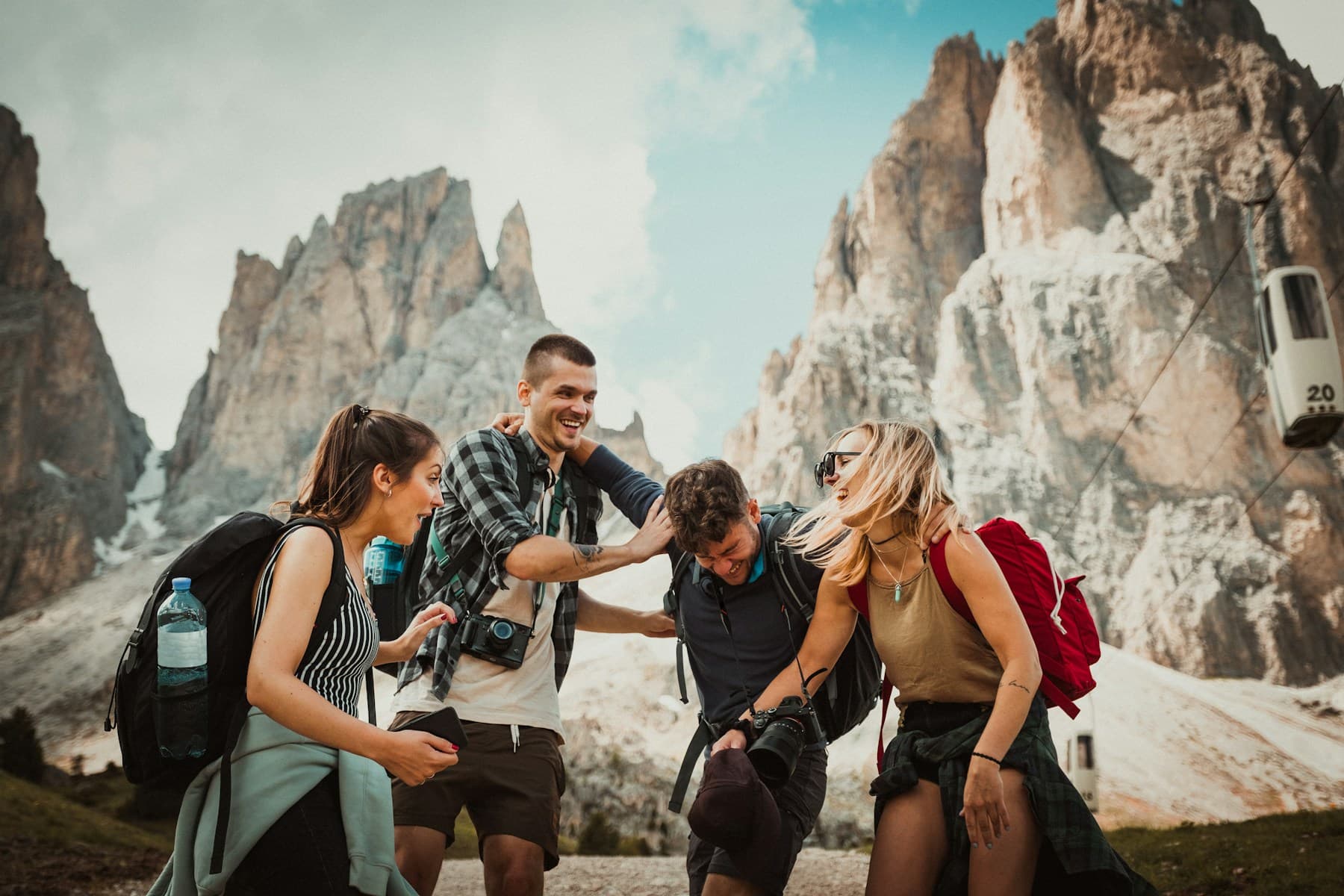 Four friends laughing together on a mountain trip